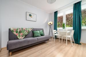 a living room with a couch and a table at Apartament Stella in Częstochowa