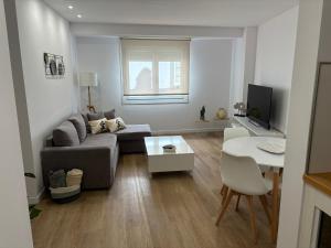 a living room with a couch and a table at Apartamentos turísticos Demar in O Grove