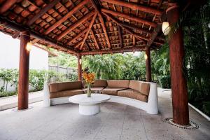 un pavillon avec des canapés et une table sur un patio dans l'établissement Punta Marina Casa 7, à Zihuatanejo