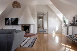 a living room with a couch and a fireplace at Cozy 3 -bedroom apartment in middle of Visby in Visby
