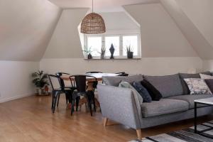 a living room with a couch and a table at Cozy 3 -bedroom apartment in middle of Visby in Visby +16 photos