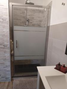 a shower with a glass door in a bathroom at La Piemontesina in Nizza Monferrato
