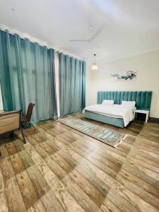 a bedroom with a bed and a wooden floor at ALHakim chalet in Arzat +12 photos