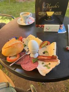 a table with a plate of food and a cup of coffee at Apartment Diez in Diez +7 photos