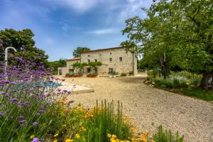 a garden with flowers in front of a building at Stone Villa Istria Private Pool Paradise in Šumber