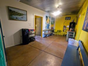 a living room with yellow walls and wooden floors at Pelican Spa in Truth or Consequences +12 photos