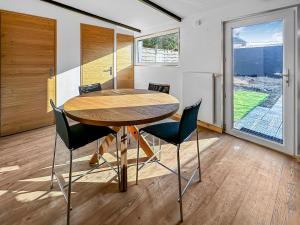 a dining room with a wooden table and chairs at Retraite Paisible, Jardin, Plages et Centre Animé in Dunkerque