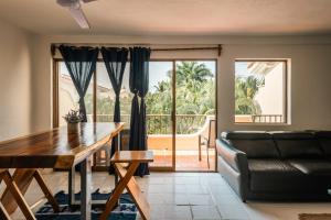 a living room with a table and a couch at 3Br Penthouse Villa at Flamingos Golf in Ixtapa