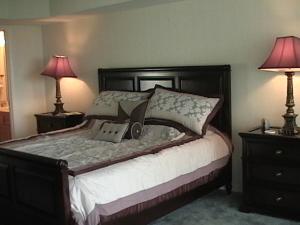 a bedroom with a large bed with two lamps at OSAGE VISTAS at Four Seasons Lake Ozark in Four Seasons +5 photos