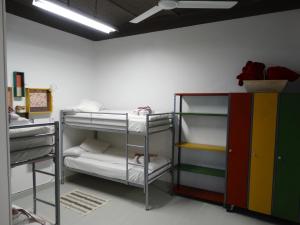 a room with three bunk beds in a room at Can Barraca Loft Figueres in Figueres