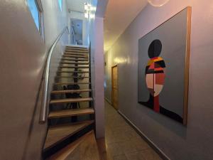a staircase in a house with a painting on the wall at Hostal 53 Boutique Santo Domingo in Santo Domingo +76 photos