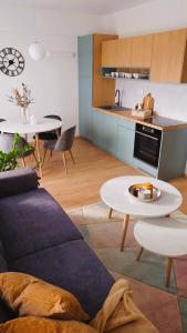 a living room with a couch and a table at Apartmán NAD RIEKOU in Bešeňová