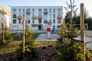 a building with christmas trees in front of a building at Apartmán NAD RIEKOU in Bešeňová