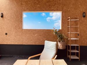 a table and a chair in a room with a window at The Rounds in Pembrokeshire
