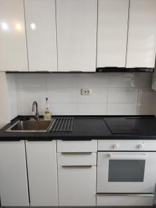 a white kitchen with a sink and a stove at Luxury 2 Rooms Free Parking Air Conditioning Espresso Netflix Superb Modern Bright View Balcony Self Check in Militari in Bucharest