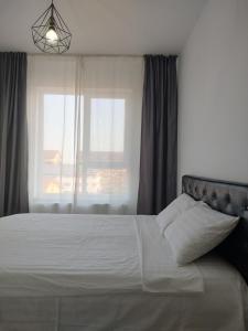 a bedroom with a large bed with a window at Luxury 2 Rooms Free Parking Air Conditioning Espresso Netflix Superb Modern Bright View Balcony Self Check in Militari in Bucharest +20 photos