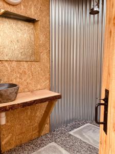 a bathroom with a sink and a metal wall at The Rounds in Pembrokeshire +26 photos