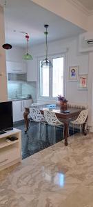 a kitchen with a dining room table and chairs at Asimelia Luxury Apartment in Heraklio