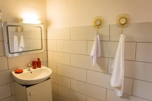 a bathroom with a sink and a mirror at Bungalow Rubis in Le Gosier