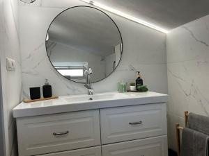 a bathroom with a white sink and a mirror at Escapada in Puigcerdà +15 photos