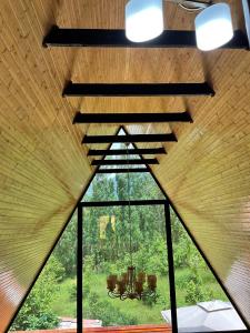 a room with a large window with a chandelier at Aframe Villa Qabala in Gabala +14 photos