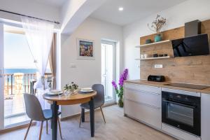 a kitchen with a table and a dining room at Apartmani Doro in Vela Luka