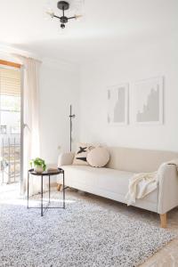 ein weißes Wohnzimmer mit einem weißen Sofa und einem Tisch in der Unterkunft Apartamento Esperanza by Clabao in Logroño