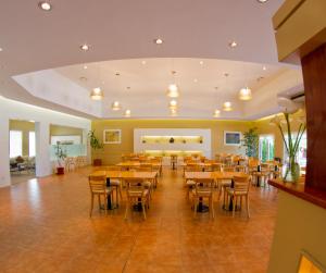 a restaurant with wooden tables and chairs in a room at Family Inn in San Rafael