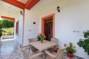 a dining room with a table and chairs at Villa Xherimeja Family Oasis in Berat