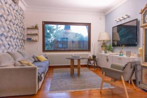 a living room with a couch and a table and a window at Villa Aureliana with pool near San Peter in Rome