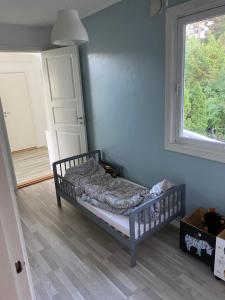 a bedroom with a bed in a room with a window at Flott sørlandshus leies ut in Arendal