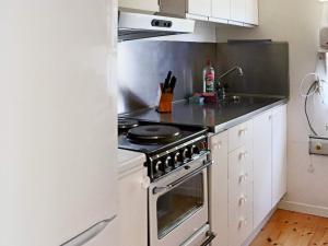 a kitchen with a stove top oven in a kitchen at Lovely holiday home near the beach-By Traum in Mellbystrand