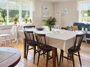 a dining room with a white table and chairs at 5 star holiday home in Urshult in Urshult
