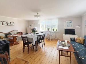 a living room with a table and chairs and a couch at 5 star holiday home in Urshult in Urshult