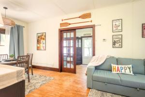 a living room with a blue couch and a table at The Cowdry Cottage - Pet-Friendly - Canoe - Bikes in Alexandria