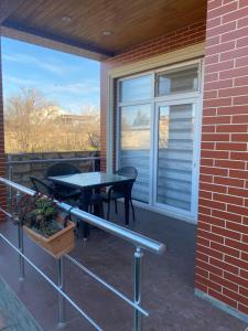 a patio with a table and chairs and a window at Summer house nearCaspian sea Fatmai, Baku Дачный дом на берегу моря, Фатмаи, Баку in Baku