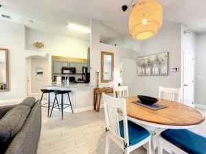 a kitchen and living room with a table and a couch at Sunshine Cove in Haines City