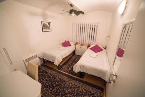 a small room with two beds and a ceiling at Guesthouse Kod Keme in Sarajevo