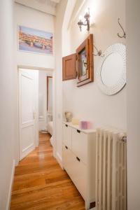a bathroom with a sink and a mirror on the wall at Il Gigliolo Apartment in Florence