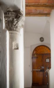 a white column in a hallway with a door at Il Gigliolo Apartment in Florence