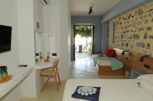a room with a bed and a table in a room at Despina Studios in Kokkari