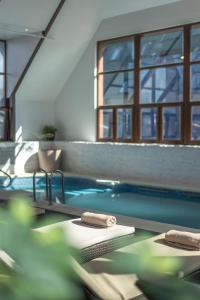 a swimming pool with two towels on the edge of it at Courtyard by Marriott Puerto Montt in Puerto Montt