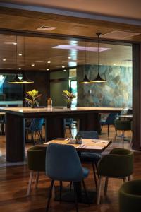 a dining room with a table and chairs at Courtyard by Marriott Puerto Montt in Puerto Montt