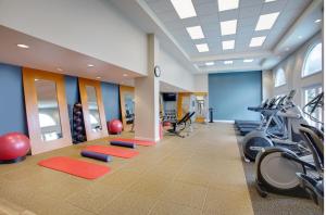 a gym with treadmills and exercise equipment in a building at Hilton Naples in Naples