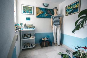 a mannequin standing in a corner of a room at Tabia Condo in Ljubuški
