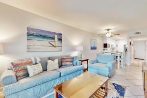 una sala de estar con un sofá y dos sillas en Tradewinds 07, en Destin