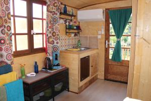 a kitchen with a sink and a counter in a room at Roulotte Lou Gregau in Saintes-Maries-de-la-Mer