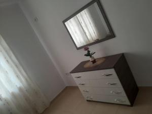 a dresser with a mirror on top of it at Apartment Cela Vlore in Vlorë