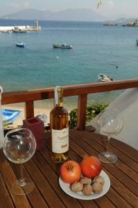 a table with a bottle of wine and two glasses at Despina Studios in Kokkari