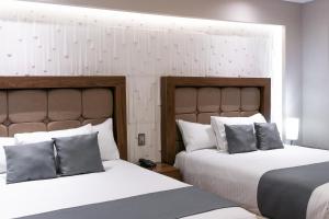 Postel nebo postele na pokoji v ubytování Hotel Arthemisa